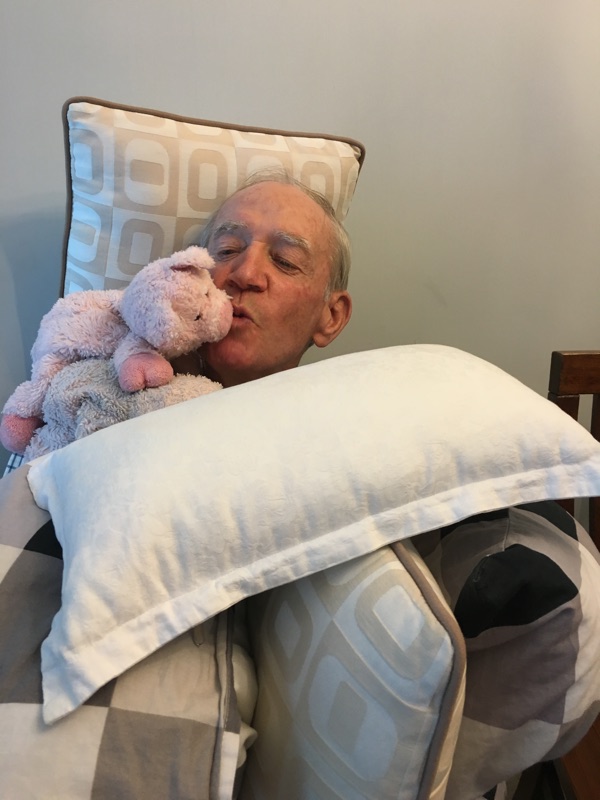 Dad giving the toy pig a kiss